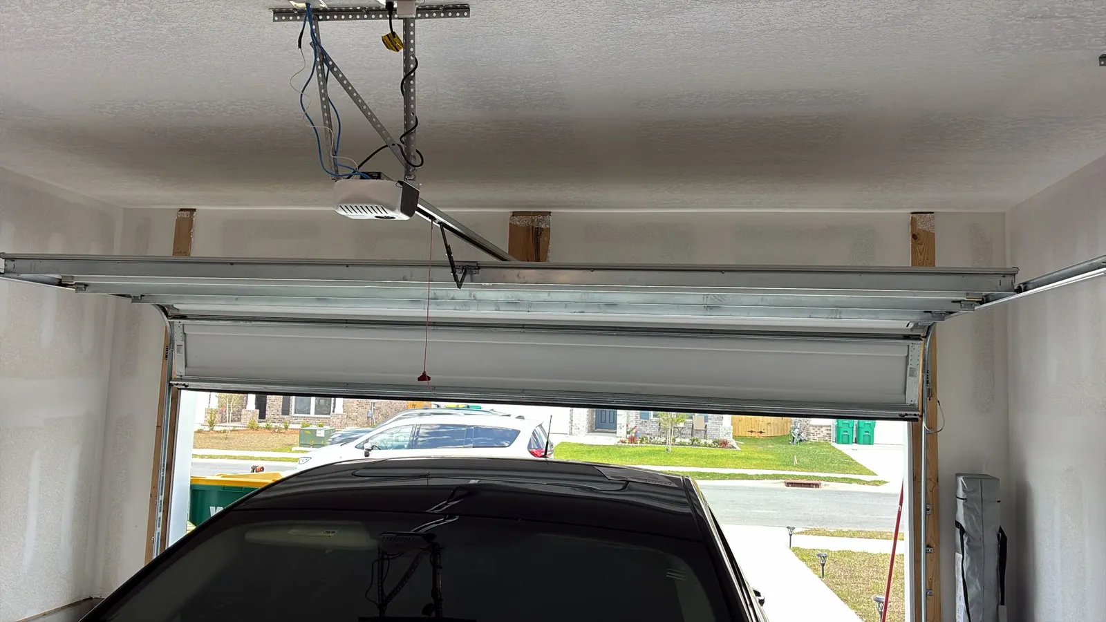 Garage door opener rail with the door open to the driveway