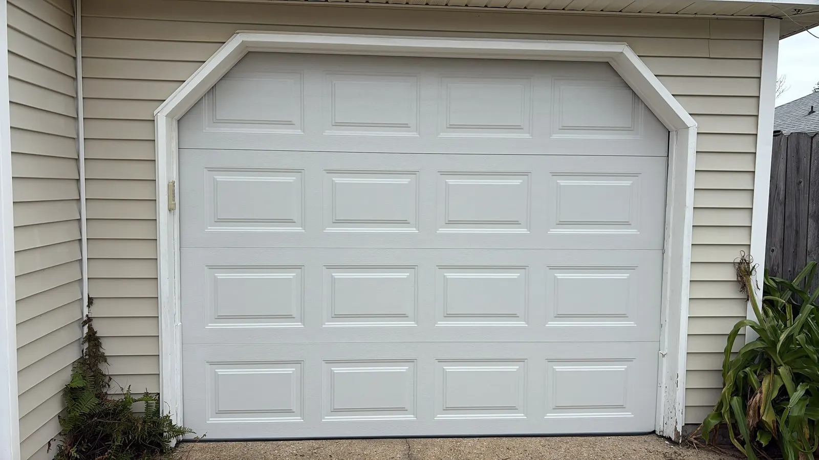 White raised-panel garage door after installation