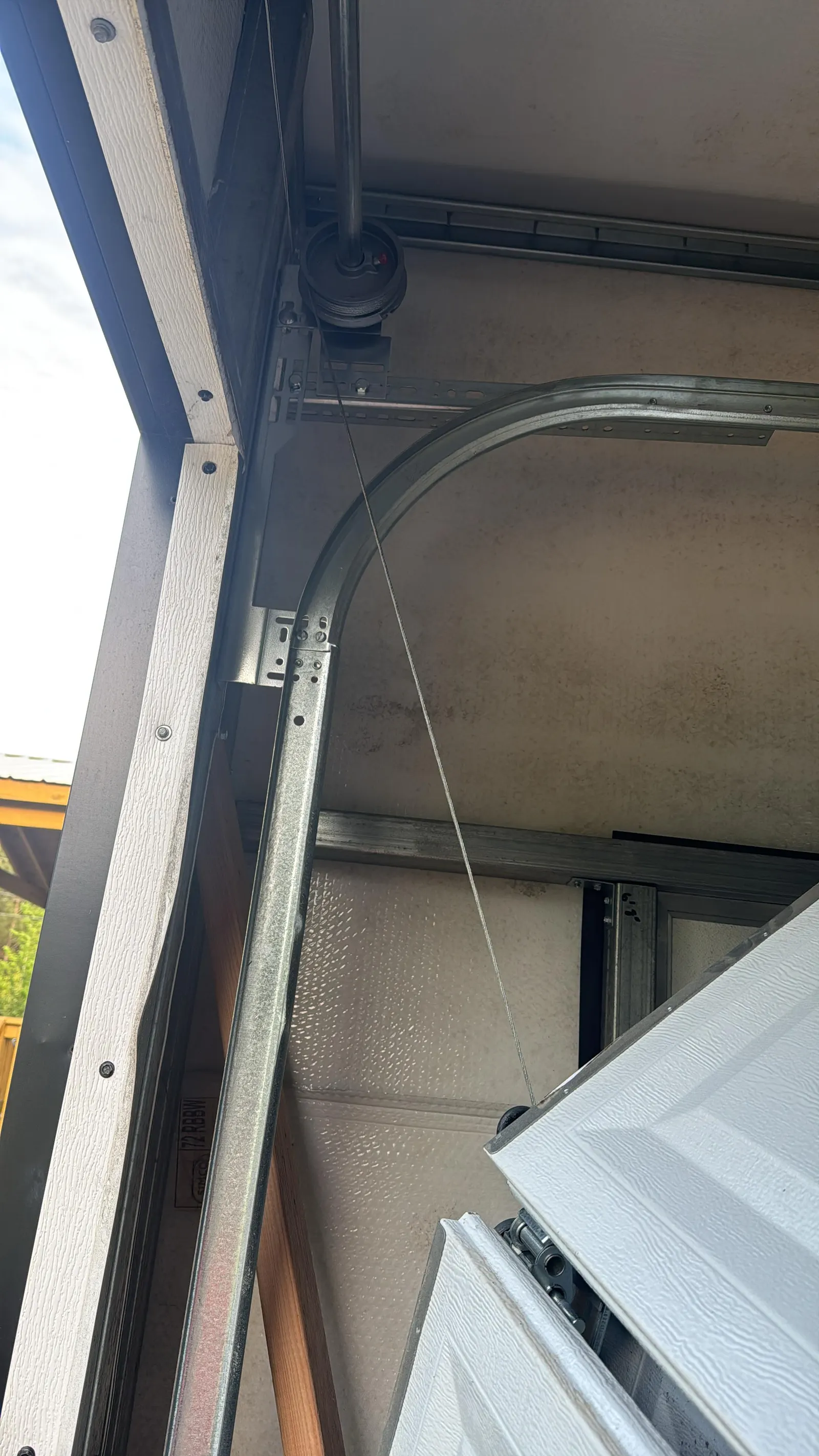 Curved horizontal track and lift cable on a residential garage door