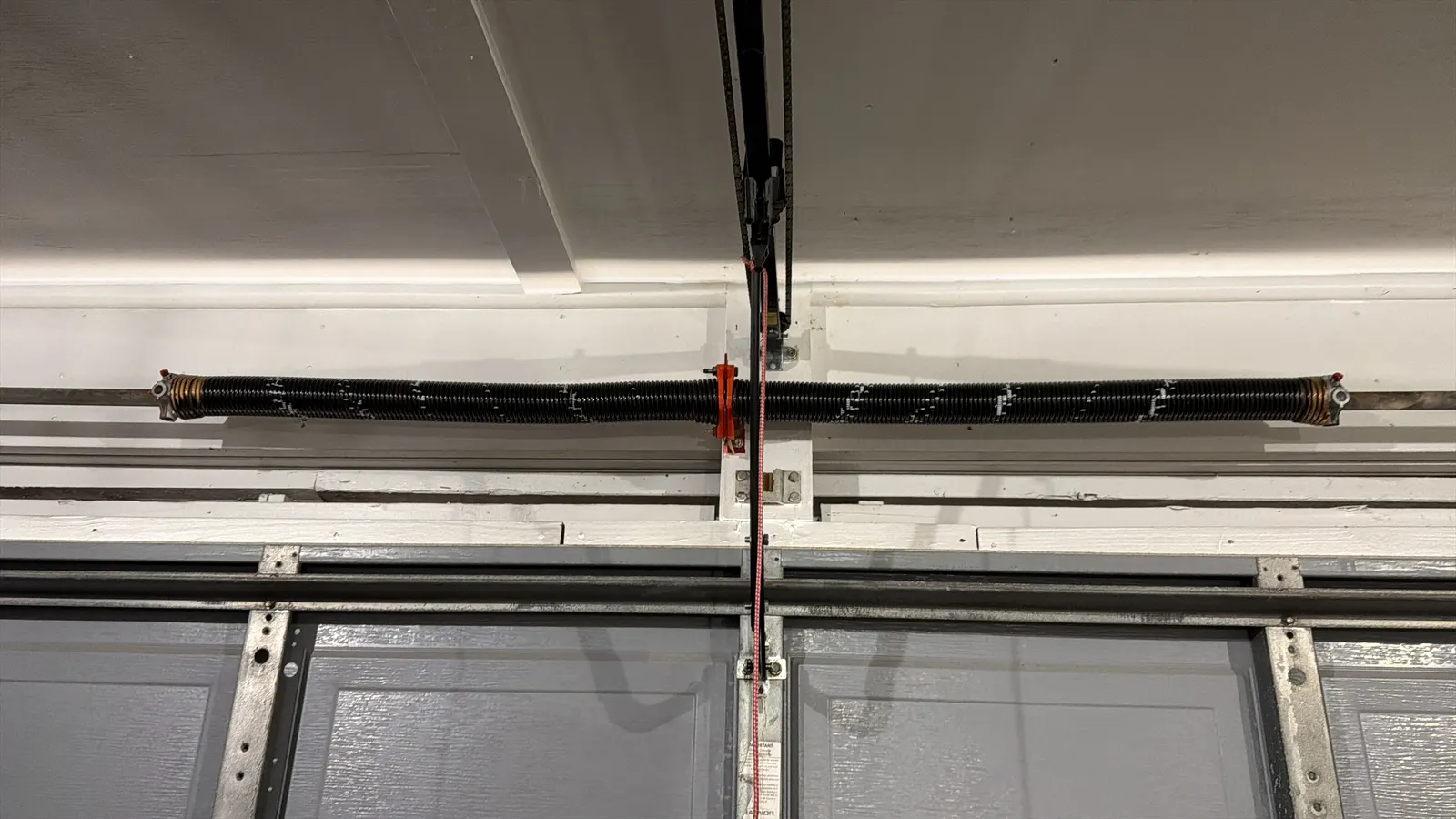 Opener rail and emergency release on a residential garage door