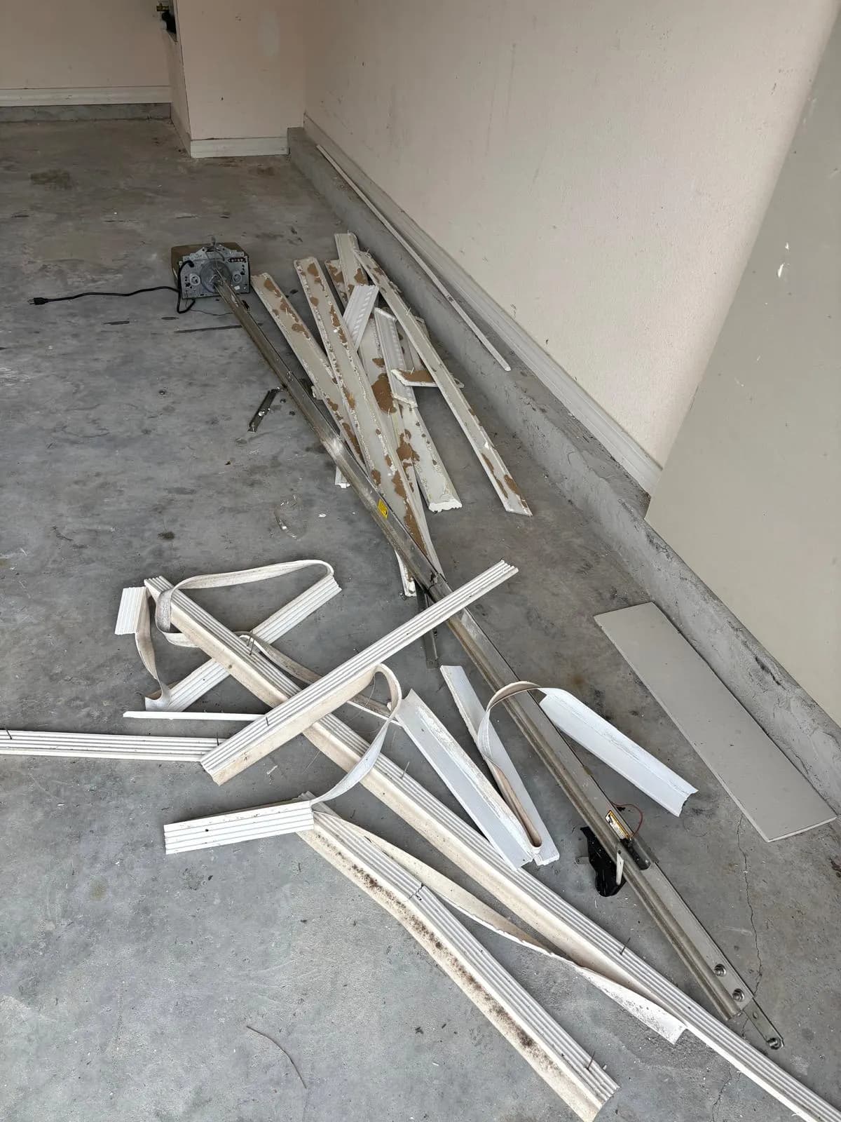 Old garage door panels removed during a door replacement