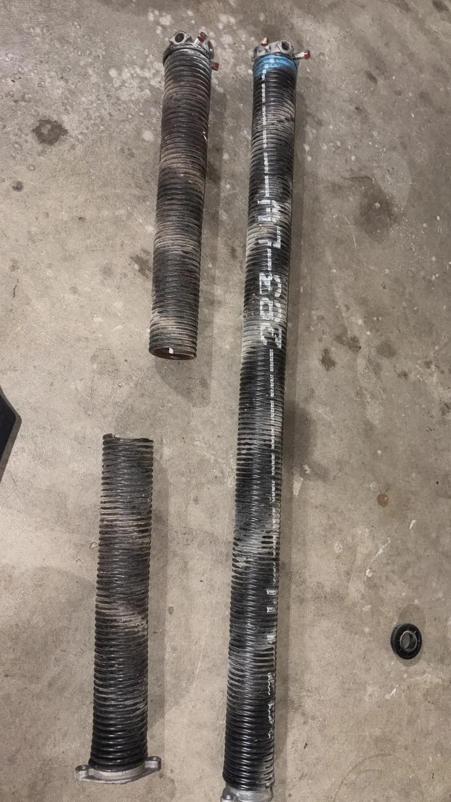Broken torsion spring with the gap where the coil snapped