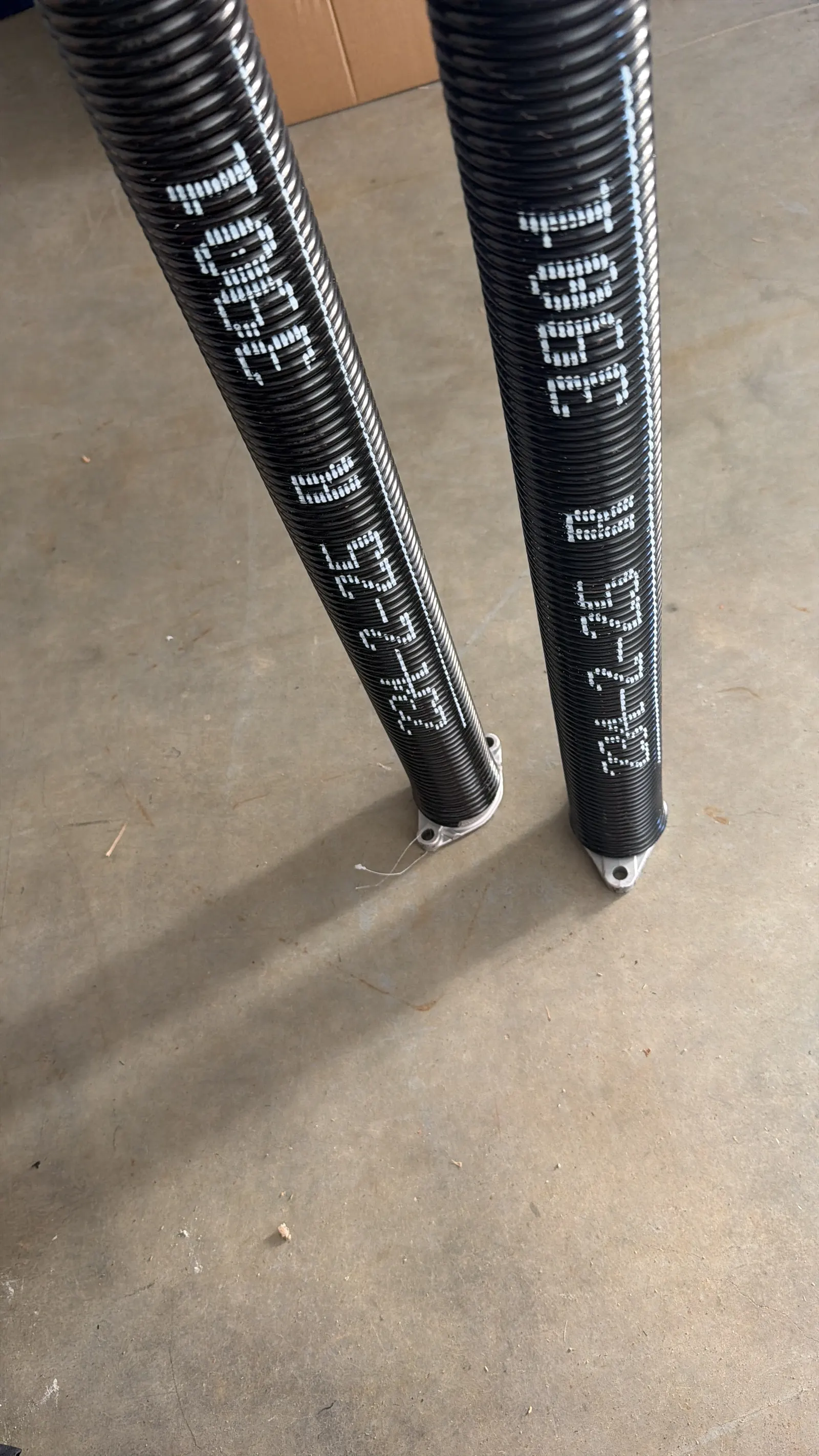 New torsion springs labeled with wire size before installation