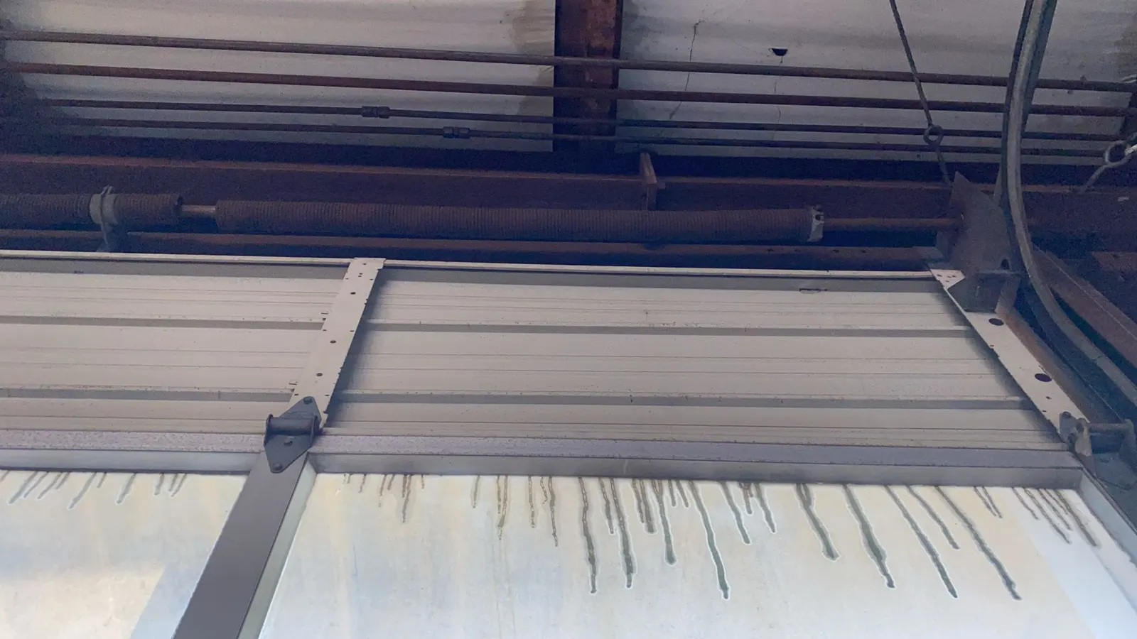 Commercial roll-up door hood and slats, close-up